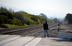 A man crosses the Union Pacific Railroad tracks at Cutting Blvd. in Richmond, Calif. on Monday, March 24, 2014. (Kristopher Skinner/Bay Area News Group)